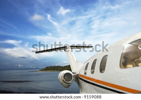 private jet flying over tropical Island