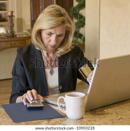 Mature woman paying bills on the internet