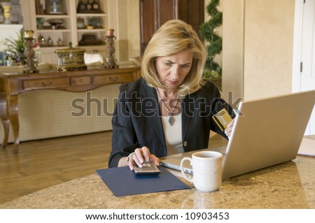 Mature woman paying bills on the internet