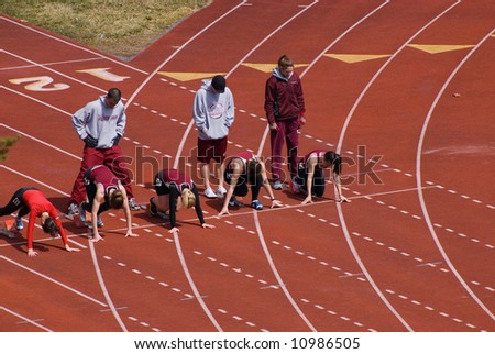 Runners Line up for the start of a track meet race.