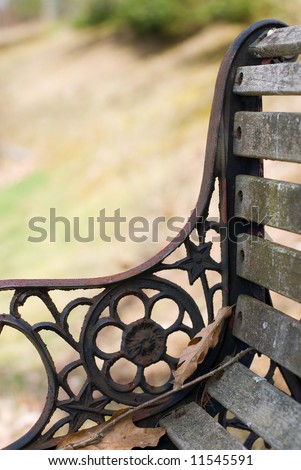 Detail view of ironwork on old park bench.