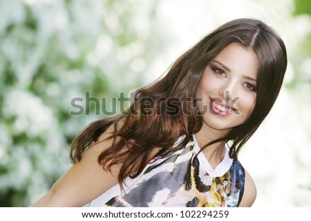 Summer girl portrait. Young woman smiling happy on sunny summer or spring day outside in park. young woman outdoors.