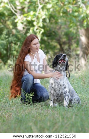 young happy woman and dog outdoors on natural background