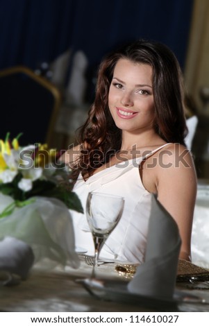 portrait of young happy beautiful woman in restaurant