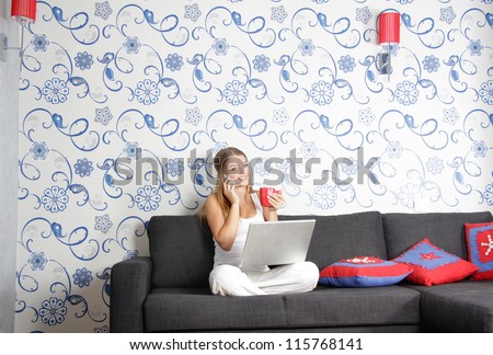 young happy smiling woman with laptop working at home