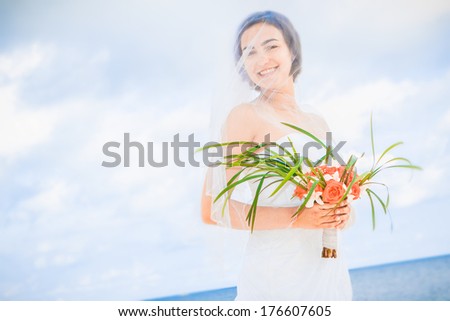 young beautiful woman in bridal wedding dress on natural background