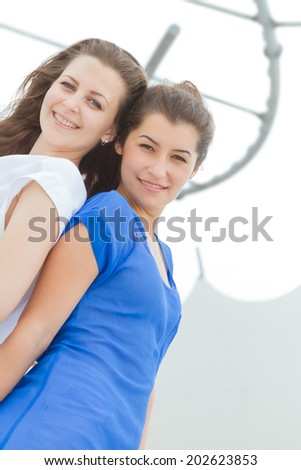 two young happy women enjoying life outdoors isolated over white