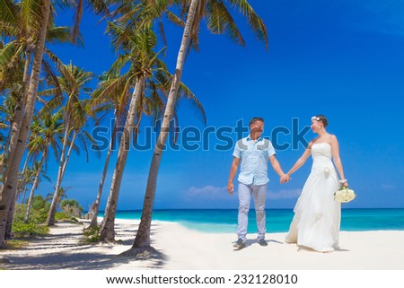 young loving couple on tropical sand beach, outdoor beach wedding