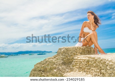 young happy beautiful woman outdoor portrait, beach and sky background