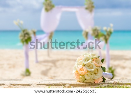 beautiful bridal bouquet on wedding arch background, outdoor beach wedding