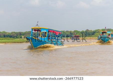 Kampong, Siem Reap, Cambodia February,27 2015: Undefined tourists going to a floating village on the Tonle Sap lake where people live on the water in the city of Siem Reap, Cambodia, February 27, 2015