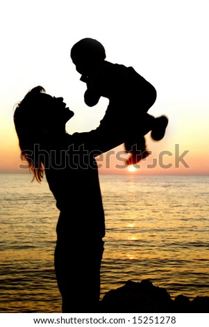 silhouettes of mother and son partly isolated over white