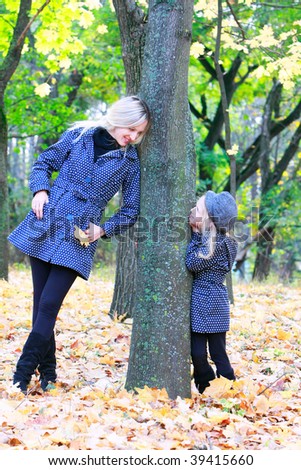 mother and daughter in autumn park