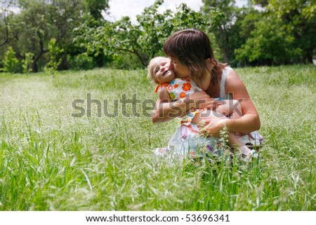 happy mother and daughter on natural background