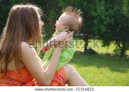 happy mother and baby on natural background