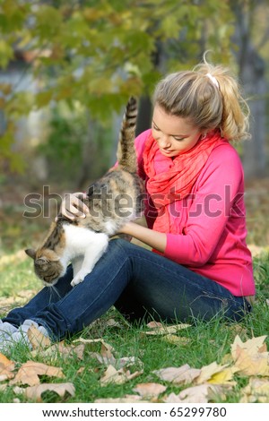 attractive young girl with cat outdoors