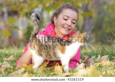 young smiling woman with cat outdoors