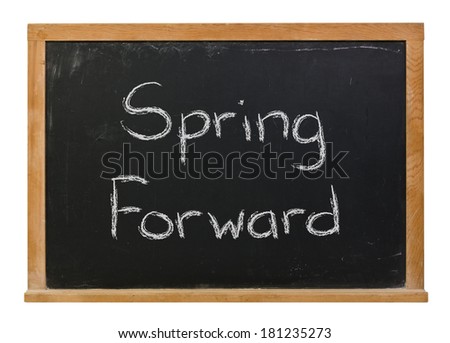 Spring Forward written in white chalk on a black chalkboard isolated on white