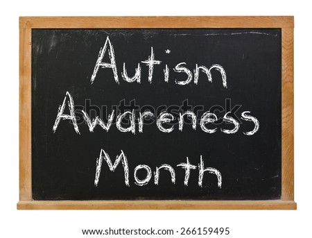 Autism awareness month written in white chalk on a black chalkboard isolated on white