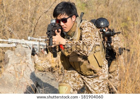 Asian men soldier training gun tactic