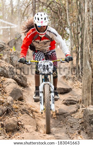 CHAINAT, THAILAND - MARCH 9 : An unidentified athlete riding a Mountain bike down hill at Thailand Championship 2014 Race 3 on March 9, 2014 at Khaoprong Track in Chainat, Thailand.