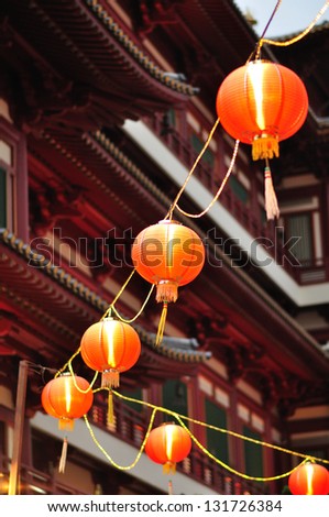 Chinese red lanterns in street, Chinatown, Singapore against Buddha Tooth Relic Temple
