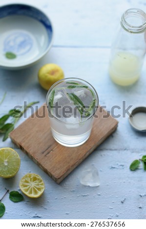 Lemonade with sage on a wooden background