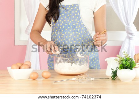 Housewife is cooking food for her family