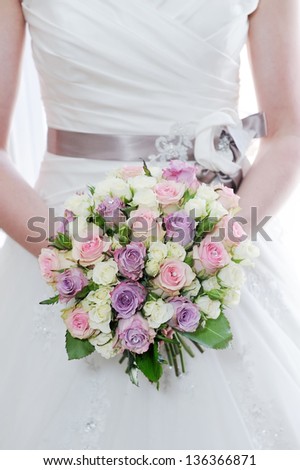 Brides flowers and dress closeup detail on wedding day