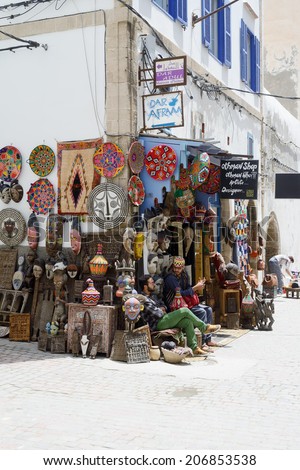 ESSAOUIRA, MOROCCO - MAY 14, 2014: Local artists selling their crafts in street on sunny day. Essaouira, Morocco. May 14, 2014.