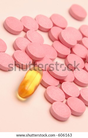 one alone with focus on pink pills just by odd one