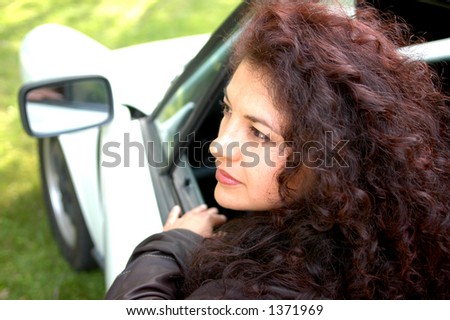 sexy woman in sports car shallow dof with focus on woman