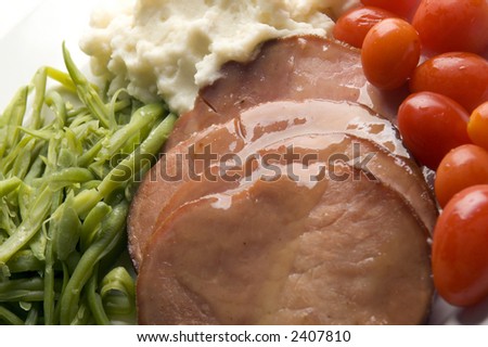 glazed ham steak dinner with garlic mashed potatoes green beans and grape tomatoes