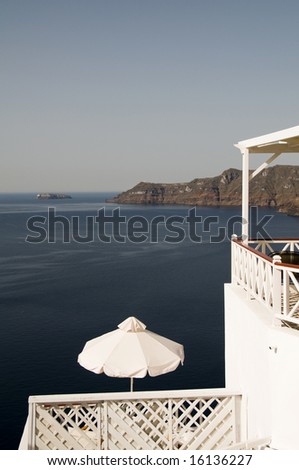 santorini view of caldera volcanic cliffs from oia ia town hotel restaurant cafe with umbrella