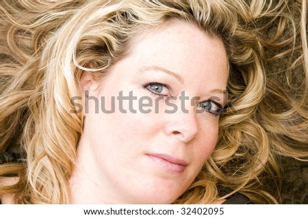 pretty middle age woman with blond hair and big blue eyes with hair loose