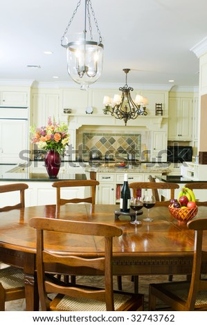 luxury home kitchen with dining table with wine and fruit