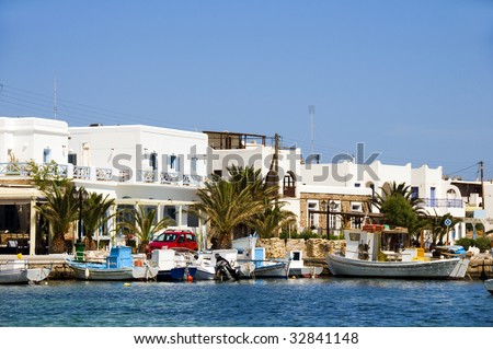 the beautiful  classic port harbor of antiparos island in the cyclades greece with boats and hotels and classic greek island architecture