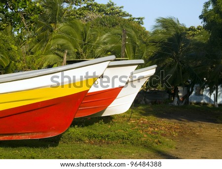 native panga fishing boats on land in jungle Big Corn Island Nicaragua