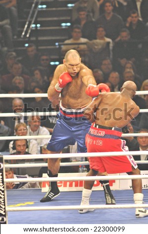 ZURICH - DECEMBER 20: Nikolai Valuev (L) throws a left punch at Evander Holyfield (R) during the WBA Heavyweight Championship fight on December 20, 2008 in Zurich.  Holyfield lost the bout.