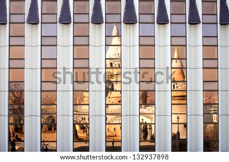 Fishermen\'s bastion reflecting in modern building window in Budapest, Hungary