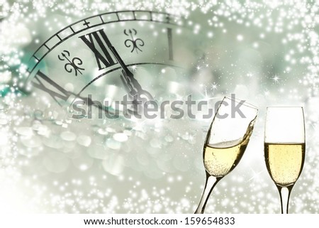 Glasses with champagne against fireworks and clock close to midnight