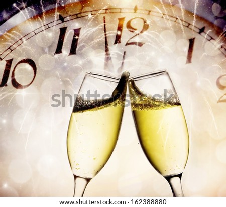 Wine glasses and clock at midnight