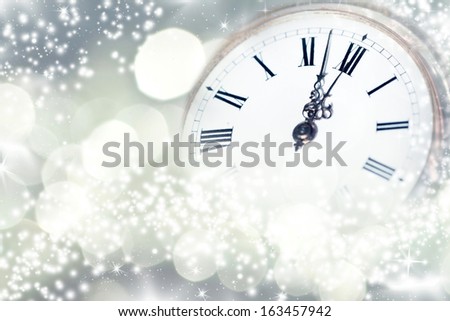 New Year's at midnight - Old golden clock with stars and snowflakes