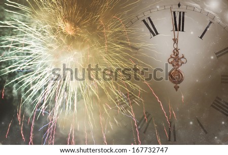 New Year\'s at midnight  - fireworks, and clock close to midnight