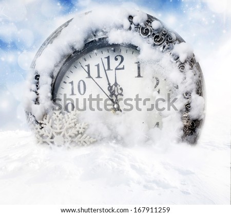 Old clock in snow