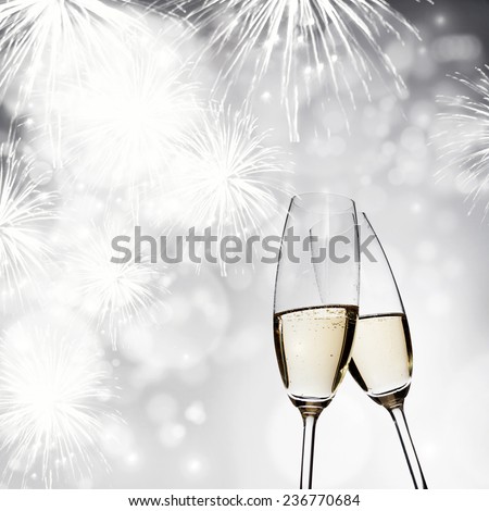 New Year's - toasting with champagne glasses against fireworks and holiday lights