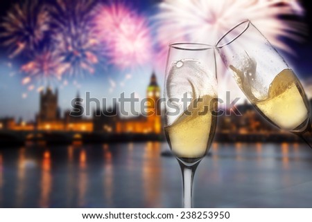Toasting with champagne in London - Westminster abbey with fireworks in the background