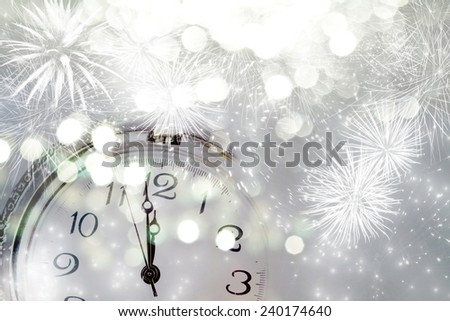 New Year\'s at midnight - Old clock with fireworks and holiday lights