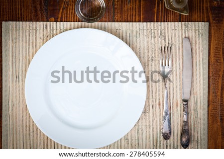 Table setting for two with empty plates - rustic wooden table