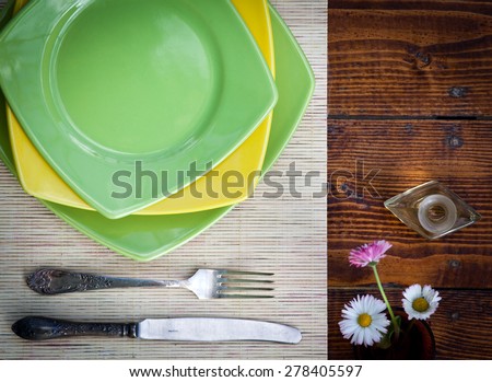 Table setting for two with empty plates - rustic wooden table